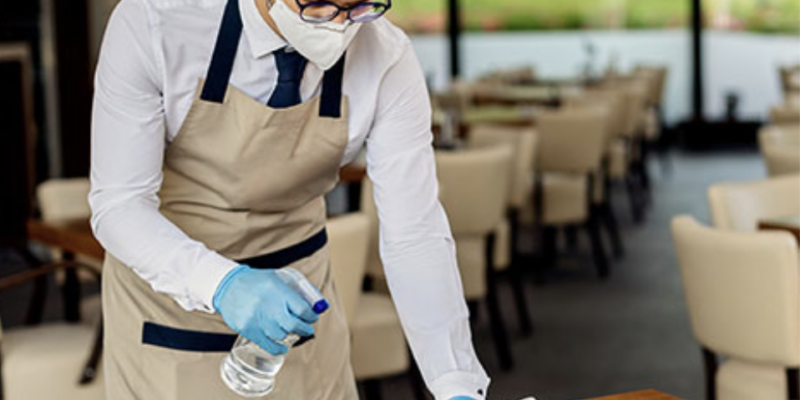 cleaning restaurant table with spray