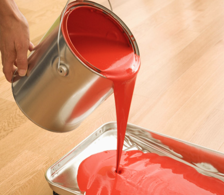 red paint pouring from can