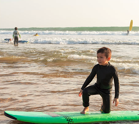 kids surfing at beach