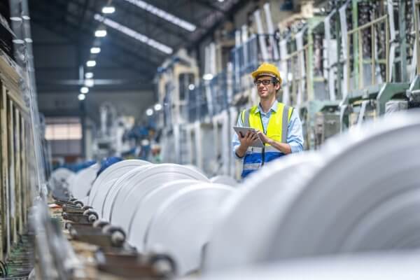 Manufacturers Engineer and tablet working at plastic bag manufacturers.