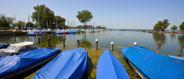 covered boats at lake