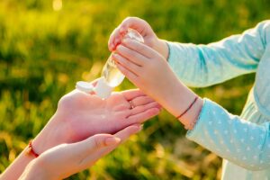 applying hand sanitizer to hands