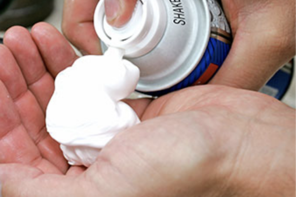 shaving gel being sprayed in hand