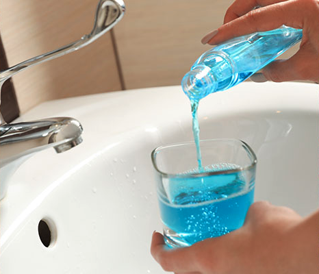 blue liquid being poured in to glass