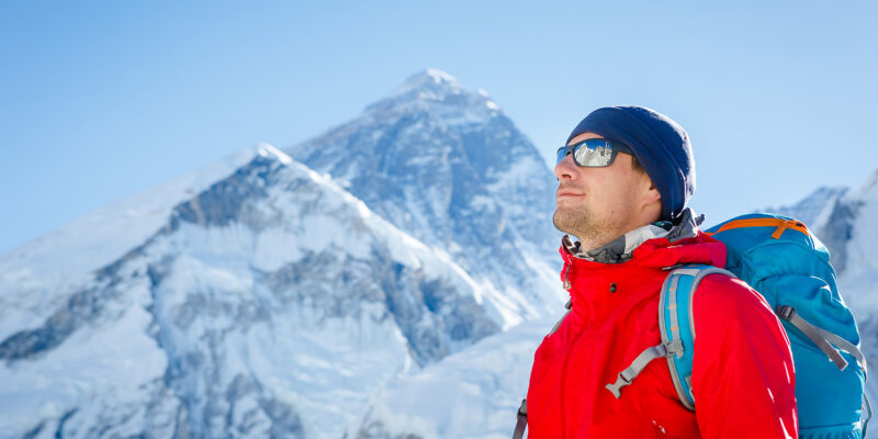 backpacker hiking in snow