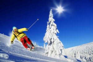 Skier skiing downhill in mountains